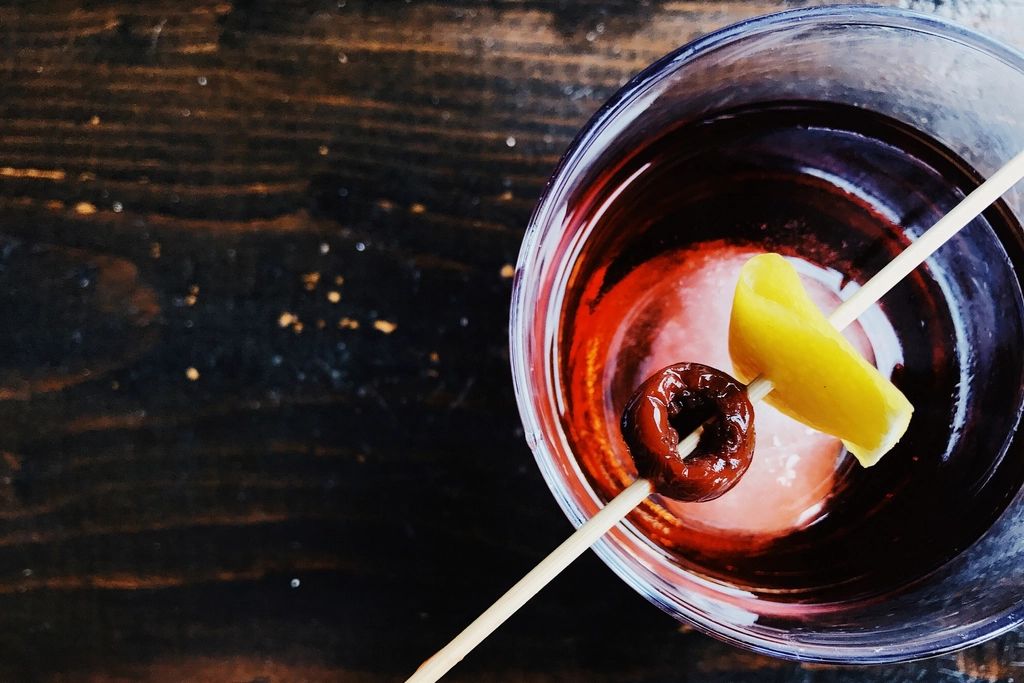 A cocktail being finished at the bar